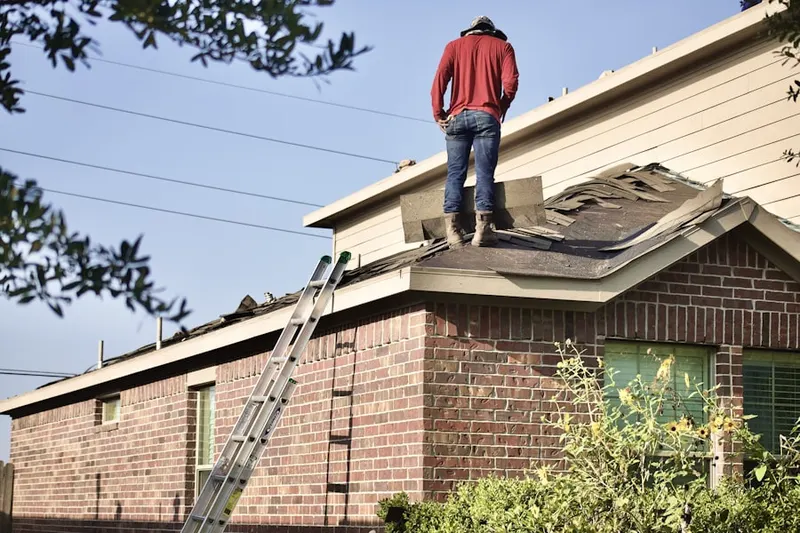 Professional roofer working on a residential roof in Dorchester